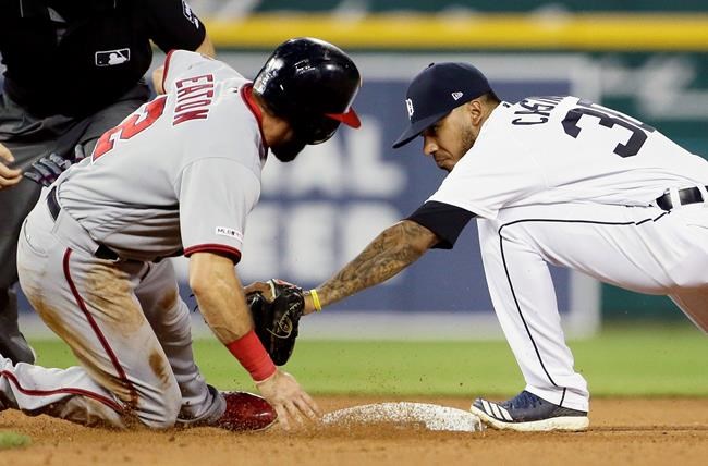 Washington Nationals' Adam Eaton (2) is tagged out by second baseman Detroit Tigers' Harold Castro (30) while trying to advance to second base on a fly out by Anthony Rendon during the eighth inning of a baseball game Friday, June 28, 2019, in Detroit. (AP Photo/Duane Burleson)