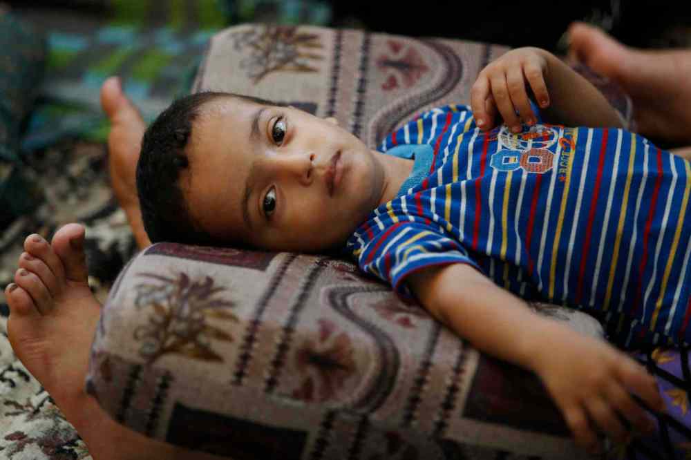 Lefteris Pitarakis / The Associated Press
Two and a half-year-old Muhammad Al Masri rests on his mother's legs in a classroom at a United Nations school where hundreds of families have sought refuge after fleeing their homes following heavy Israeli forces' strikes, in Jebaliya refugee camp, Gaza Strip, Friday, July 25, 2014.