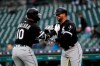 Chicago White Sox's Yoan Moncada (10) celebrates his solo home run with Yonder Alonso, against the Detroit Tigers during the first inning of a baseball game in Detroit, Friday, April 19, 2019. (AP Photo/Paul Sancya)