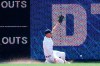 Detroit Tigers center fielder JaCoby Jones can't reach a Philadelphia Phillies' Rhys Hoskins fly ball that went for a triple in the first inning of a baseball game in Detroit, Wednesday, July 24, 2019. (AP Photo/Paul Sancya)