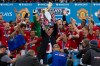 Manchester United's manager Sir Alex Ferguson, center, lifts the premier league trophy after his last home game in charge of the club, their English Premier League soccer match against Swansea City, at Old Trafford Stadium, Manchester, England, Sunday May 12, 2013. (AP Photo/Jon Super)