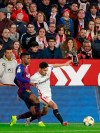 Sevilla's Jesus Navas, right, fight for the ball with FC Barcelona's Nelson Semedo, during a Spanish Copa del Rey soccer match between Sevilla and FC Barcelona at the Ramon Sanche Pizjuan stadium in Seville, Spain, Wednesday Jan. 23, 2019. (AP Photo/Miguel Morenatti)