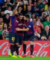 Barcelona's Messi, centre, celebrates after scoring with teammate Aleix Vidal, left, and Suarez during La Liga soccer match between Betis and Barcelona at the Benito Villamarin stadium in Seville, Spain, Sunday, March 17, 2019. (AP Photo/Miguel Morenatti)