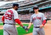 Boson Red Sox's Brock Holt is congratulated by J.D. Martinez after Holt scored against the Minnesota Twins during the second inning of a baseball game Wednesday, June 19, 2019, in Minneapolis. (AP Photo/Andy Clayton- King)