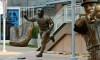 A huge and fan-popular gold glove, left, along with the statues of Minnesota Twins greats Kirby Puckett, left, and Harmon Killebrew adorn the plaza at Target Field Wednesday, March 27, 2019 in Minneapolis, one day away from the Twins' season opener against the Cleveland Indians. (AP Photo/Jim Mone)