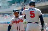 Atlanta Braves' Ozzie Albies, celebrates with Freddie Freeman after Albies' home run off Minnesota Twins pitcher Martin Perez in the first inning of a baseball game Wednesday, Aug. 7, 2019, in Minneapolis. Freeman followed up with a solo home run. (AP Photo/Jim Mone)