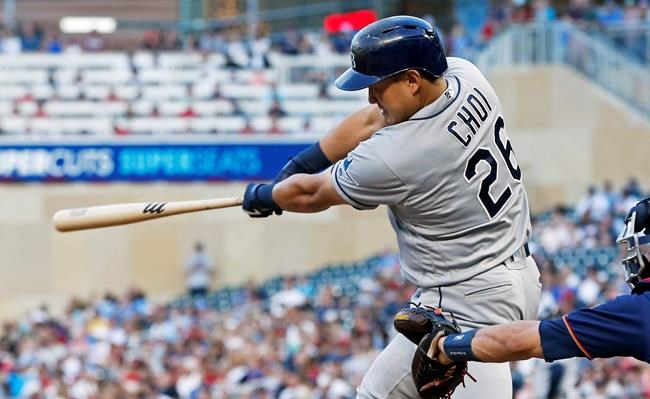 Tampa Bay Rays' Ji-Man Choi follows through on a single off Minnesota Twins pitcher Jake Odorizzi during the fourth inning of a baseball game Wednesday, June 26, 2019, in Minneapolis. (AP Photo/Jim Mone)
