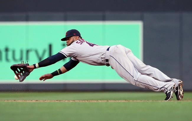 Cleveland Indians first baseman Carlos Santana makes a diving attempt but can't get the ball as Minnesota Twins' Max Kepler singles during the third inning of a baseball game Friday, Aug. 9, 2019, in Minneapolis. (AP Photo/Jim Mone)