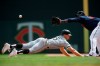 Chicago White Sox's Adam Engel, left, dives safely back to first base as Minnesota Twins first baseman Miguel Sano waits for the ball in the fourth inning of a baseball game Wednesday, Aug. 21, 2019, in Minneapolis. (AP Photo/Jim Mone)
