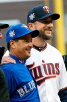 Toronto Blue Jays manager Charlie Montoya, left, and Minnesota Twins manager Rocco Baldelli pose with umpires before a baseball game Monday, April 15, 2019, in Minneapolis. The two friends were on Tampa Bay's coaching staff last season and spent several years in the Rays organization together. Both got hired as first-time managers this season. (AP Photo/Jim Mone)