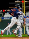Minnesota Twins' Jorge Polanco, left, scores on a double by Nelson Cruz off Toronto Blue Jays pitcher Trent Thornton, right, in the third inning of a baseball game Wednesday, April 17, 2019, in Minneapolis. (AP Photo/Jim Mone)