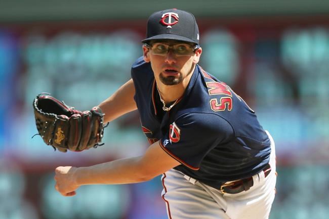 Minnesota Twins pitcher Devin Smeltzer watches a pitch against the Kansas City Royals in the sixth inning of a baseball game Sunday, Aug. 4, 2019, in Minneapolis. (AP Photo/Jim Mone)