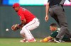 Minnesota Twins second baseman Luis Arraez, left, waits for the ball as Oakland Athletics' Ramon Laureano slides safely into second on a double in the fourth inning of a baseball game Friday, July 19, 2019, in Minneapolis. (AP Photo/Jim Mone)