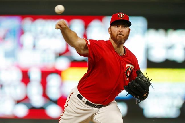 Newly signed Minnesota Twins pitcher Sam Dyson makes his home debut as he throws against the Kansas City Royals during the eighth inning of a baseball game Friday, Aug. 2, 2019, in Minneapolis. The Twins won 11-9. (AP Photo/Jim Mone)