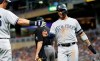 New York Yankees' DJ LeMahieu, left, congratulates Gleyber Torres after he scored on a hit by New York Yankees' Mike Tauchman in the sixth inning of a baseball game against the Minnesota Twins, Monday, July 22, 2019, in Minneapolis. The Twins won 8-6. (AP Photo/Jim Mone)