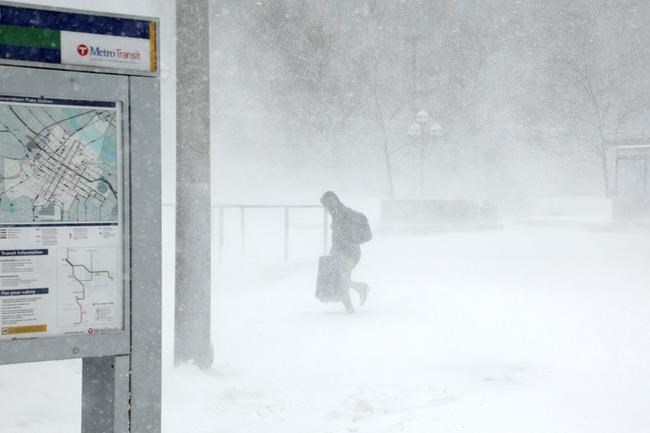 Anthony Souffle / Minneapolis Star Tribune
A traveler walks through the snow and ice to get to the Metro Government Center Plaza station as the snow picked up in downtown Minneapolis Saturday.