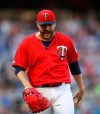 Minnesota Twins starting pitcher Martin Perez reacts while watching a replay of a first-inning triple play that got him out of a jam against the New York Yankees in baseball game Monday, July 22, 2019, in Minneapolis. (Jeff Wheeler/Star Tribune via AP)