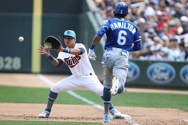 Minnesota Twins' Ehire Adrianza catches the ball at first to get out Kansas City Royals' Billy Hamilton after he bunted a ground ball during the fifth inning of a baseball game Sunday, June 16, 2019, in Minneapolis. Adrianza caught the ball from pitcher Martin Perez. (AP Photo/Stacy Bengs)