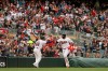 Minnesota Twins' Nelson Cruz, right, high-fives third base coach Tony Diaz, left, after hitting his 400th career home run in the first inning of a baseball game against the Kansas City Royals, Sunday, Sept. 22, 2019, in Minneapolis. (AP Photo/Stacy Bengs)