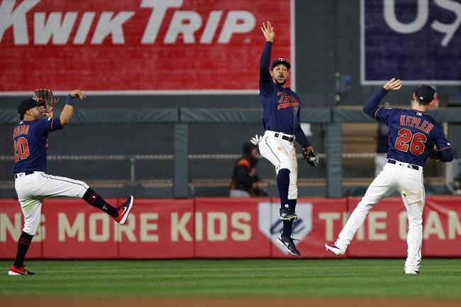 Minnesota Twins' Eddie Rosario, left, Byron Buxton, center, and Max Kepler, right, celebrate on the field after the team's 6-0 win against the Detroit Tigers in a baseball game Friday, May 10, 2019, in Minneapolis. (AP Photo/Stacy Bengs)