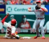 Cincinnati Reds' Derek Dietrich (22) forces out St. Louis Cardinals' Jose Martinez (38) and completes a double play by getting Yadier Molina at first in the second inning of a baseball game, Saturday, April 27, 2019 at Busch Stadium in St. Louis. (AP Photo/Bill Boyce)