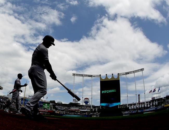 New York Yankees' Luke Voit, second from left, and Aaron Hicks warm up before batting in the first inning of the first baseball game in a double header against the Kansas City Royals, Saturday, May 25, 2019, in Kansas City, Mo. (AP Photo/Charlie Riedel)