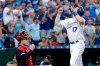 Kansas City Royals' Hunter Dozier celebrates as he crosses the plate after hitting a two-run home run during the first inning of a baseball game against the Cleveland Indians Thursday, July 25, 2019, in Kansas City, Mo. (AP Photo/Charlie Riedel)