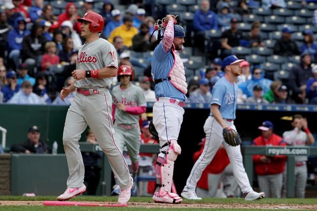 Philadelphia Phillies' J.T. Realmuto (10) crosses the plate in front of Kansas City Royals catcher Cam Gallagher to score on a two run single by Odubel Herrera during the fifth inning of a baseball game Sunday, May 12, 2019, in Kansas City, Mo. (AP Photo/Charlie Riedel)