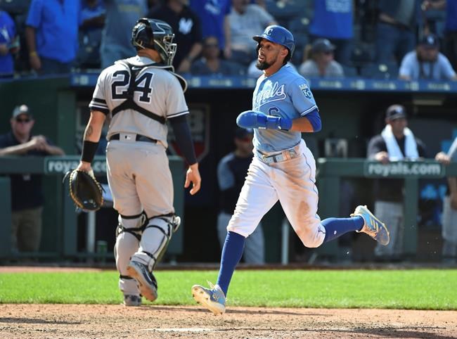 Kansas City Royals' Billy Hamilton crosses home past New York Yankees catcher Gary Sanchez to score the game-winning run on a Whit Merrifield single in the 10th inning during a baseball game Sunday, May 26, 2019, in Kansas City, Mo. The Royals won 8-7. (AP Photo/Ed Zurga)