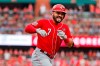 Cincinnati Reds' Eugenio Suarez celebrates as he rounds the bases after hitting a two-run home run during the third inning in the first baseball game of a doubleheader against the St. Louis Cardinals, Sunday, Sept. 1, 2019, in St. Louis. (AP Photo/Jeff Roberson)
