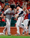 Atlanta Braves' Brian McCann, left, takes his base on a bases loaded walk as Freddie Freeman scores during the 10th inning of a baseball game against the St. Louis Cardinals, Sunday, May 26, 2019, in St. Louis. (AP Photo/Jeff Roberson)