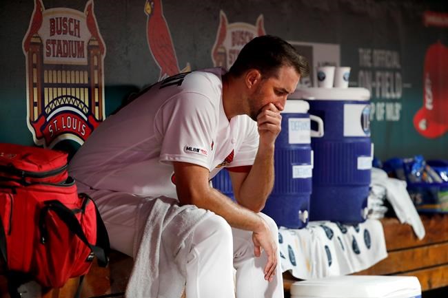St. Louis Cardinals starting pitcher Adam Wainwright sits in the dugout during the fifth inning of the team's baseball game against the Chicago Cubs on Tuesday, July 30, 2019, in St. Louis. (AP Photo/Jeff Roberson)
