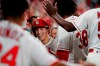 St. Louis Cardinals' Tommy Edman is congratulated by teammates after hitting a double then scoring on a throwing error by Pittsburgh Pirates shortstop Kevin Newman during the sixth inning of a baseball game Saturday, Aug. 10, 2019, in St. Louis. (AP Photo/Jeff Roberson)