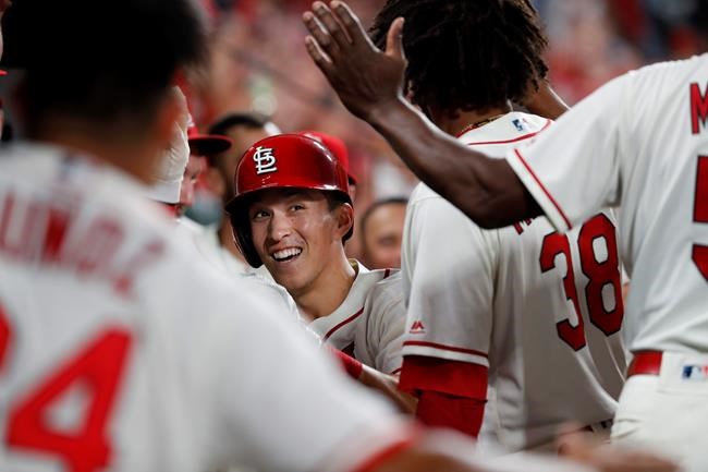 St. Louis Cardinals' Tommy Edman is congratulated by teammates after hitting a double then scoring on a throwing error by Pittsburgh Pirates shortstop Kevin Newman during the sixth inning of a baseball game Saturday, Aug. 10, 2019, in St. Louis. (AP Photo/Jeff Roberson)