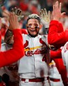 St. Louis Cardinals' Yadier Molina is congratulated by teammates in the dugout after hitting a two-run home run during the sixth inning of the team's baseball game against the Los Angeles Dodgers on Wednesday, April 10, 2019, in St. Louis. (AP Photo/Jeff Roberson)