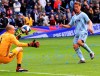 Sporting Kansas City forward Krisztian Nemeth, right, chips the ball over Montreal Impact goalkeeper Evan Bush, left, for his third goal of the match Saturday, March 30, 2019, during an MLS match in Kansas City, Mo. (Ryan Weaver/The Kansas City Star via AP)