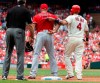 St. Louis Cardinals' Yadier Molina, right, pulls up the back of Los Angeles Angels first baseman Albert Pujols' jersey as he stands on first base during fifth inning of a baseball game Saturday, June 22, 2019, in St. Louis. (AP Photo/L.G. Patterson)
