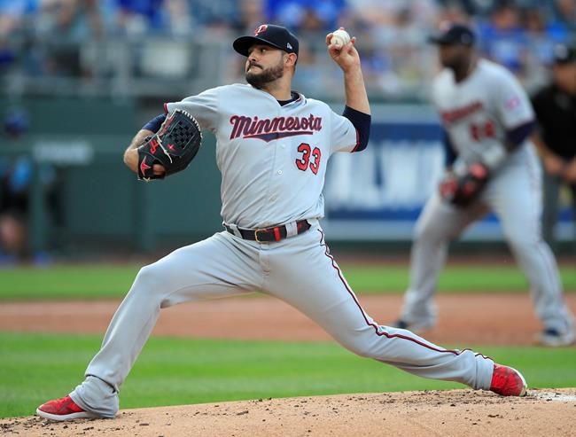 Minnesota Twins starting pitcher Martin Perez delivers to a Kansas City Royals batter during the first inning of a baseball game at Kauffman Stadium in Kansas City, Mo., Friday, June 21, 2019. (AP Photo/Orlin Wagner)