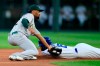 Oakland Athletics shortstop Marcus Semien, left, tags out Kansas City Royals' Whit Merrifield (15) during the first inning of a baseball game at Kauffman Stadium in Kansas City, Mo., Tuesday, Aug. 27, 2019. Merrifield was caught stealing on the play. (AP Photo/Orlin Wagner)