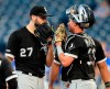 Chicago White Sox starting pitcher Lucas Giolito (27) talks with catcher James McCann (33) after a run scored in the fourth inning of a baseball game against the Kansas City Royals at Kauffman Stadium in Kansas City, Mo., Monday, July 15, 2019. (AP Photo/Orlin Wagner)