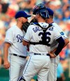 Kansas City Royals starting pitcher Glenn Sparkman, left, meets with catcher Cam Gallagher (36) and pitching coach Cal Eldred, back, after giving up a grand slam in the first inning of a baseball game against the Cleveland Indians at Kauffman Stadium in Kansas City, Mo., Saturday, July 27, 2019. (AP Photo/Orlin Wagner)