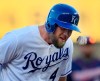 Kansas City Royals' Alex Gordon is hit on the head by a ball thrown by Minnesota Twins third baseman Willians Astudillo during the first inning of a baseball game at Kauffman Stadium in Kansas City, Mo., Thursday, June 20, 2019. Gordon was out and teammate Cheslor Cuthbert reached on a fielder's choice on the play. (AP Photo/Orlin Wagner)