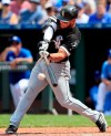 Chicago White Sox's Yoan Moncada hits an RBI-single off Kansas City Royals starting pitcher Glenn Sparkman during the seventh inning of a baseball game at Kauffman Stadium in Kansas City, Mo., Sunday, June 9, 2019. (AP Photo/Orlin Wagner)