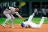Kansas City Royals' Ryan O'Hearn, right, beats the tag by Oakland Athletics shortstop Marcus Semien, left, while diving back to second base during the fourth inning of a baseball game at Kauffman Stadium in Kansas City, Mo., Tuesday, Aug. 27, 2019. (AP Photo/Orlin Wagner)