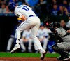 Kansas City Royals Hunter Dozier (17) is hit by a pitch from Seattle Mariners starter Felix Hernandez during the first inning of a baseball game at Kauffman Stadium in Kansas City, Mo., Monday, April 8, 2019. (AP Photo/Orlin Wagner)
