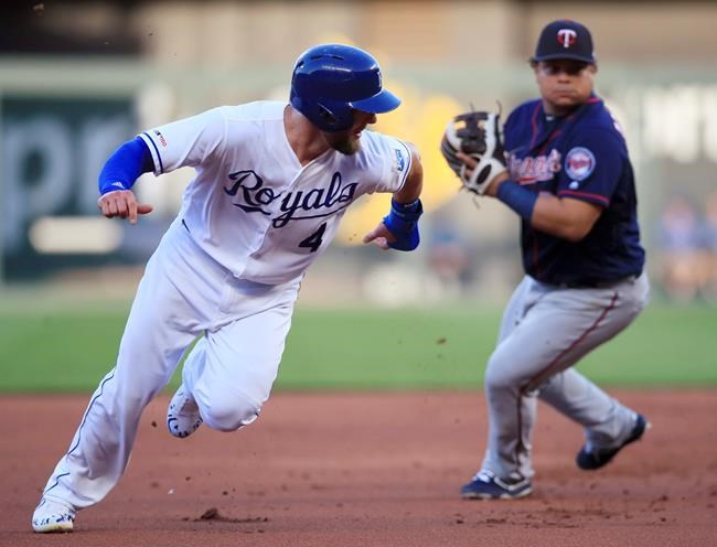Kansas City Royals' Alex Gordon looks back at Minnesota Twins third baseman Willians Astudillo in a rundown during the first inning of a baseball game at Kauffman Stadium in Kansas City, Mo., Thursday, June 20, 2019. (AP Photo/Orlin Wagner)