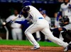 Kansas City Royals' Whit Merrifield bunts in a run during the seventh inning of the team's baseball game against the Seattle Mariners at Kauffman Stadium in Kansas City, Mo., Wednesday, April 10, 2019. The bunt gave Merrifield a 31-game hitting streak, breaking the old club record of 30 set by George Brett in 1980. (AP Photo/Orlin Wagner)
