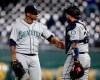 Seattle Mariners relief pitcher Roenis Elias, left, is congratulated by catcher Omar Narvaez following the team's baseball game against the Kansas City Royals at Kauffman Stadium in Kansas City, Mo., Wednesday, April 10, 2019. The Mariners defeated the Royals 6-5. (AP Photo/Orlin Wagner)