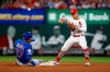 St. Louis Cardinals second baseman Kolten Wong (16) turns a double play over Chicago Cubs' Addison Russell during the fourth inning of a baseball game Friday, May 31, 2019, in St. Louis. Albert Almora was out at first. (AP Photo/Scott Kane)