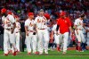 St. Louis Cardinals' Yadier Molina, center, walks toward first base as the rest of his teammates walk back to the dugout after a bench-clearing argument after he was hit by pitch during the second inning of a baseball against the Chicago Cubs, Saturday, Sept. 28, 2019, in St. Louis. (AP Photo/Scott Kane)